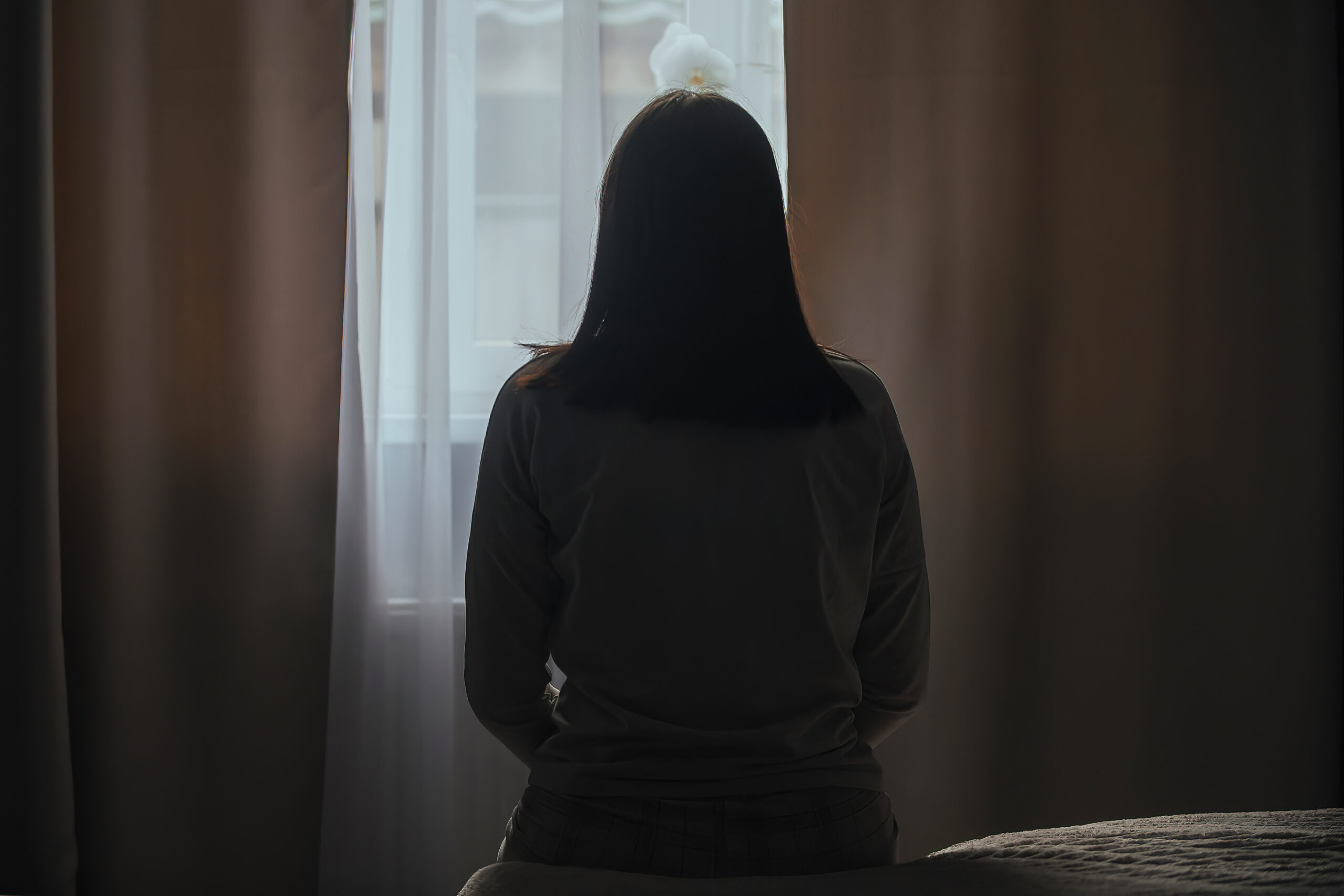 Image of a student looking out a window.